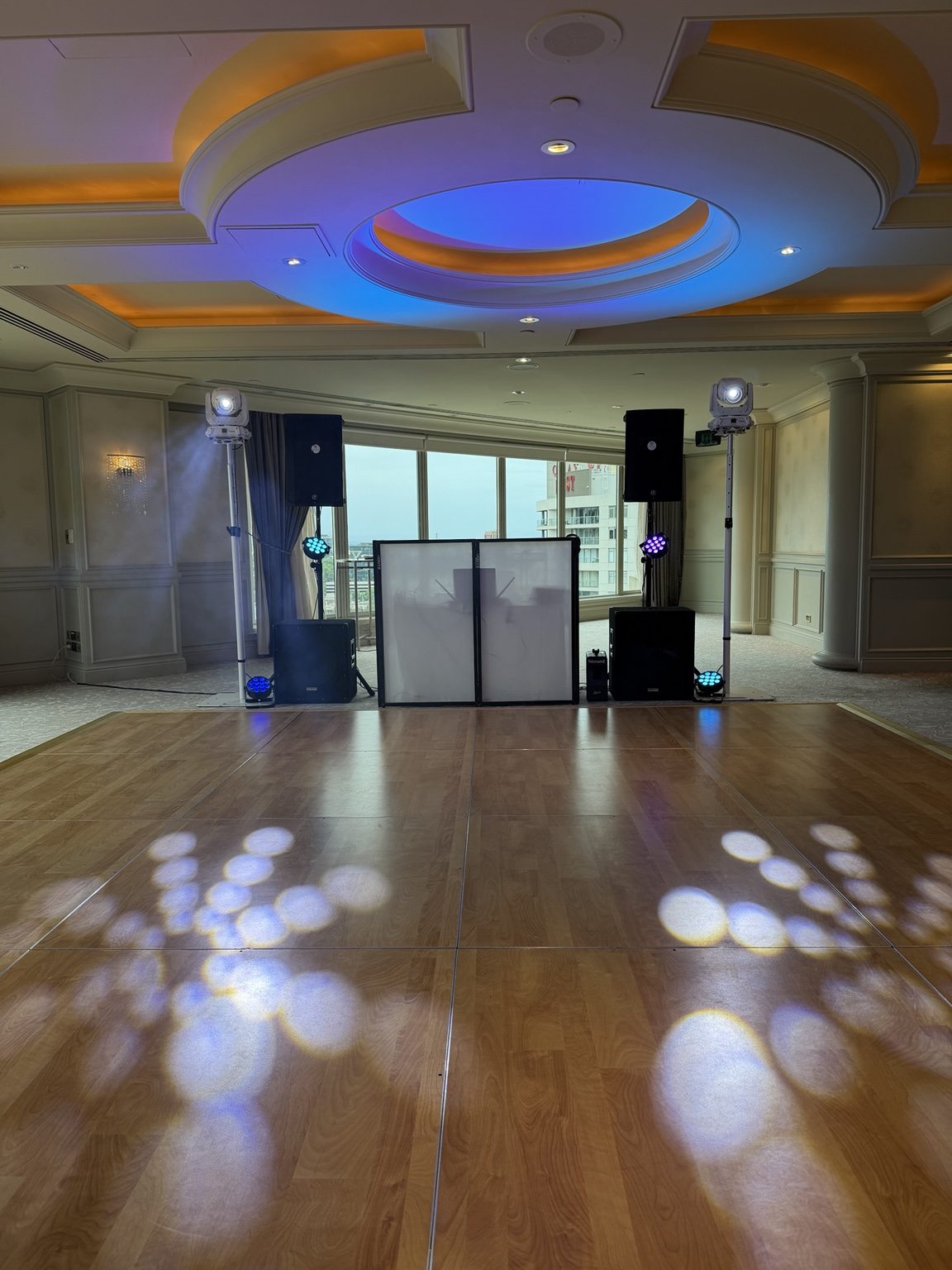 Actual DJ Vish event setup with open dance floor, PA speakers and moving-head lights